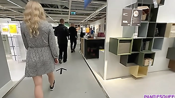 Kinky girl is stuffing anal plug in public toilet at IKEA and flashing pussy upskirt no panties publically